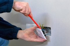An electrician installing a power socket